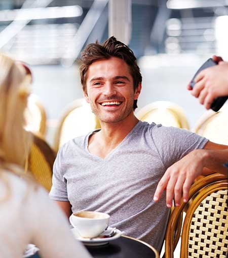 man smiling at cafe